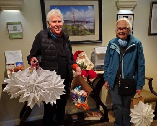 Linda and Dee deliver stars and trees to a senior home.